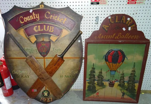 A 20th century 'Country Cricket Club' shield shaped advertising sign, 72cm wide x 102cm high, together with a 20th century 'A. Clark Ascent Balloon' h