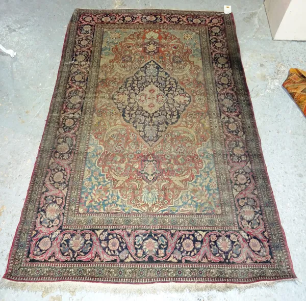 An Esfahan rug, Persian, the madder leaf and floral spray field, with a black diamond, pale indigo spandrels, a black complementary border, 212cm x 13