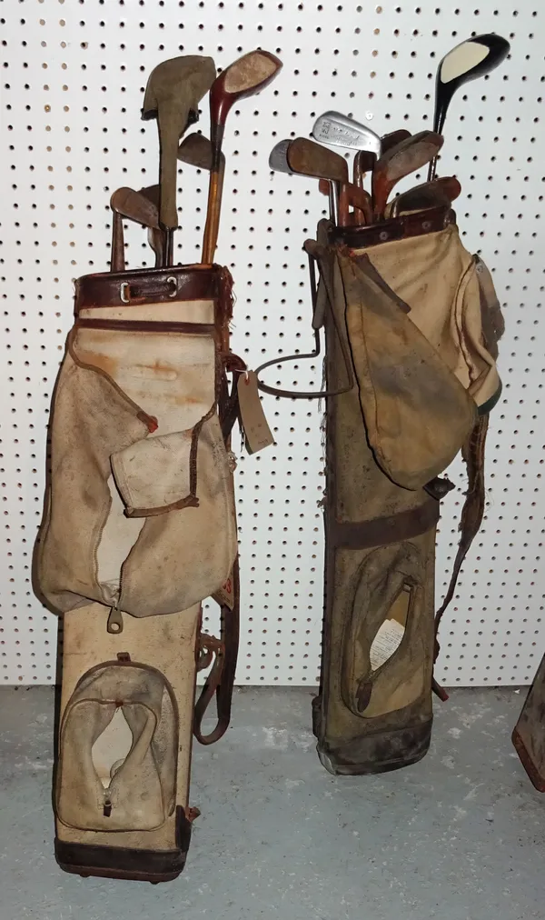 A quantity of early 20th century golf clubs and accessories, including two canvas golf bags. Add 5  CAB