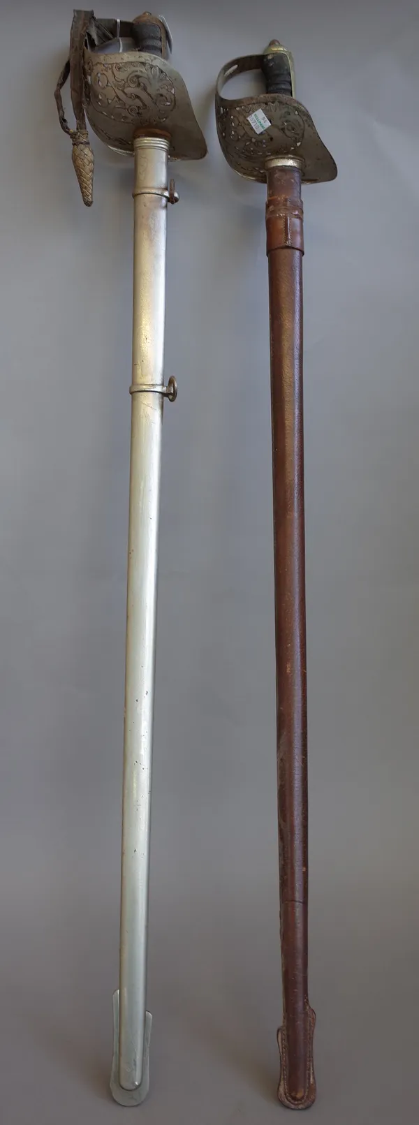 A George V Officer's dress sword and an Edwardian VII Officer's dress sword by 'Henley Brooks Ltd', each with engraved blade and scabbard, (2).