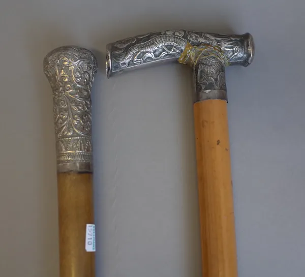 An Indian silver handled walking stick, late 19th century, with segmented horn shaft, 80cm and a Chinese silver handled walking stick, (a.f.), (2).