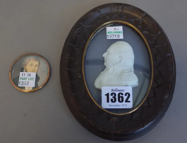 A Tassie style miniature of Louis XVIII housed in a carved wooden oval frame, 15cm high overall and one further small portrait miniature, (2).