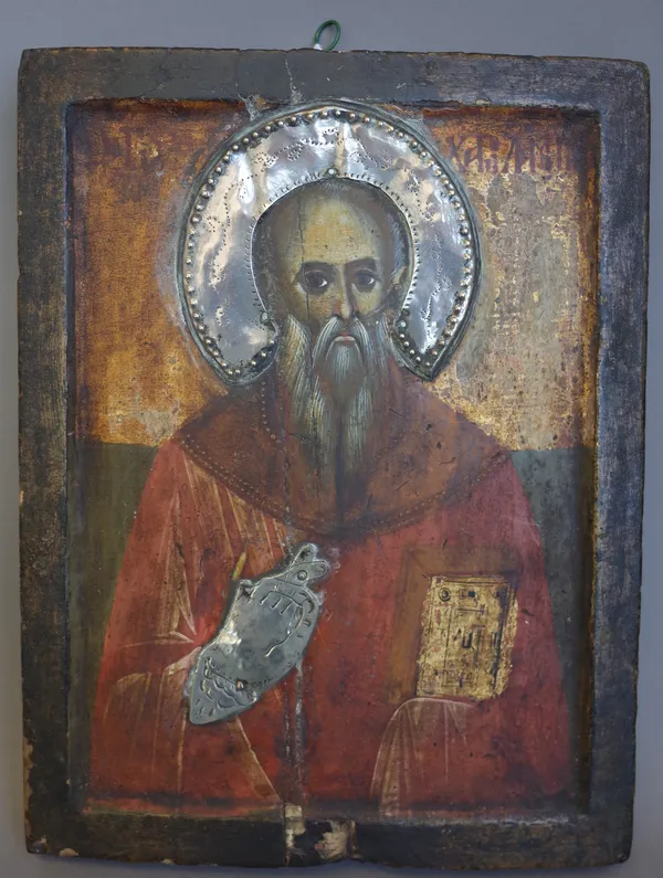 A Russian Icon, 19th century, the polychrome painted Saint with silver halo and hand, 22.5cm x 17.5cm.