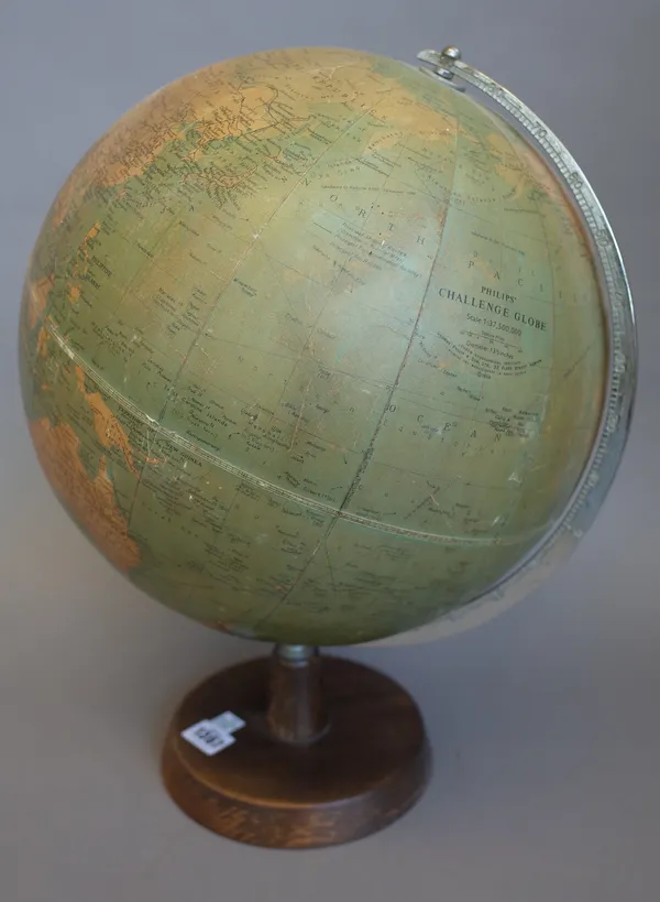 A Philips 13.5 inch Challenge Globe, circa 1958, with chromed meridian on a turned wooden base.