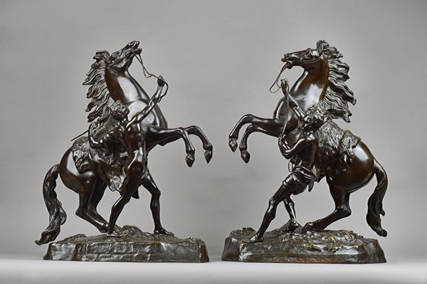 After Guillaume Coustou (French 1677 - 1746), a pair of patinated bronze Marly horses, late 19th century, signed Coustou to the base, 57.5cm high, (wi