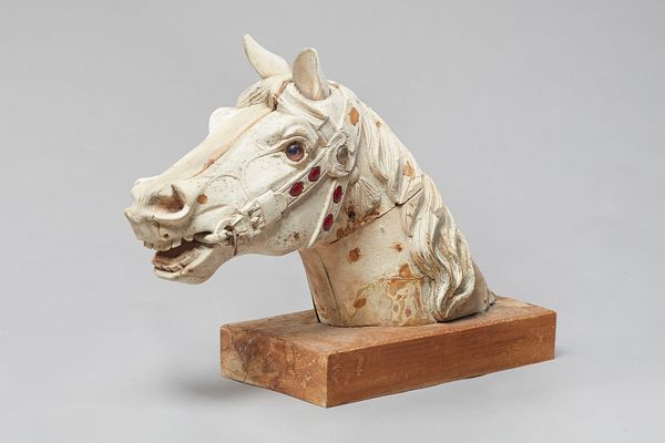 Carousel horse, carved wood horse's head, partially painted with inset coloured glass gems on a pine rectangular plinth, unsigned, 68cm wide x 47cm hi