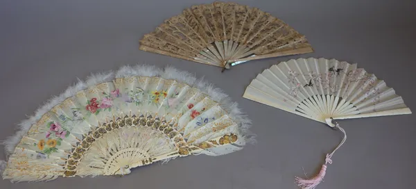 A foliate painted feather fan, c.1900, with gilt pierced ivory sticks (25cm) and four further fans. (5)