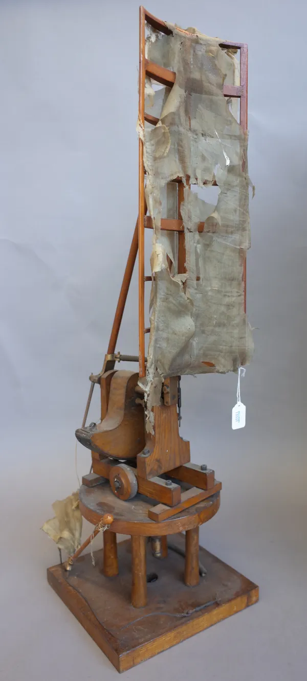 An unusual oak and metal mounted wind measuring machine, with curved silk sail over an adjustable body and square plinth base, 76cm high, cased.