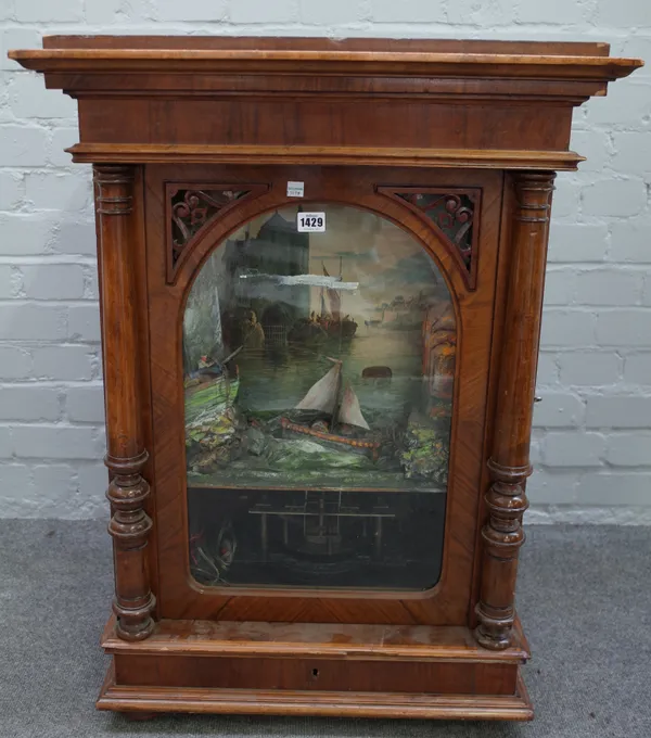 A Swiss walnut cased polyphon, 19th century, with automation movement depicting a sailing ship on rocky seas, 85cm high.