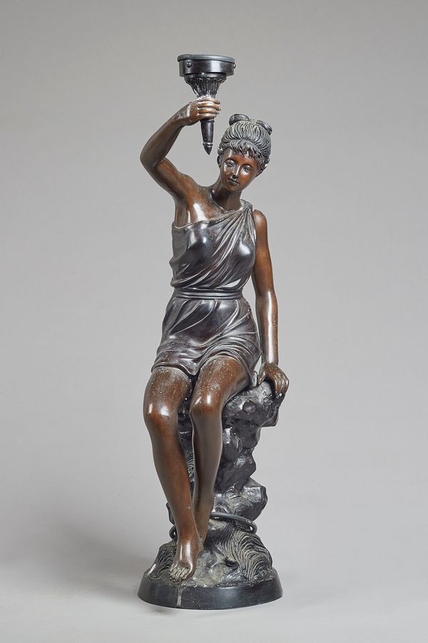 Figural bronze table lamp, modern, modelled and cast as a classical Grecian female holding a torch on a naturalistic base, unsigned 88cm high. Illustr
