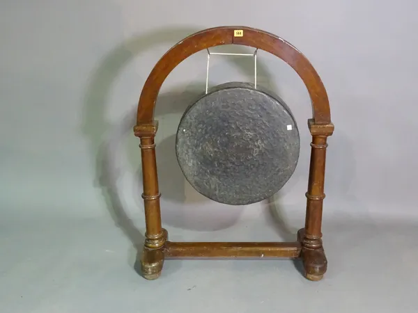 A 20th century gong within an arch top oak stand, 79cm wide x 102cm high.  J5