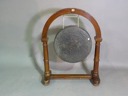A 20th century gong within an arch top oak stand, 79cm wide x 102cm high.  J5