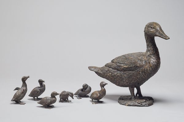 A patinated bronze duck and six ducklings, modern, unsigned, duck 51cm high. (7)