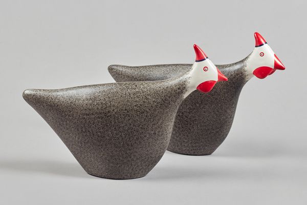 A pair of polychrome decorated ceramic guinea fowl of stylised form, unsigned, 32cm high. (2)Illustrated.  AS