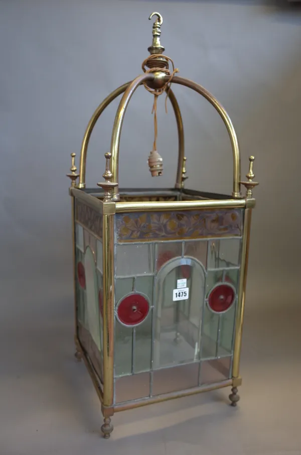 An Edwardian gilt metal and coloured glass lantern of square form with turned finials, 80cm high, (a.f).