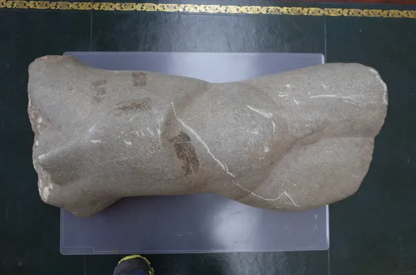'Stone Torso', late 20th century, carved stone male torso, recumbent, unsigned, 79cm.