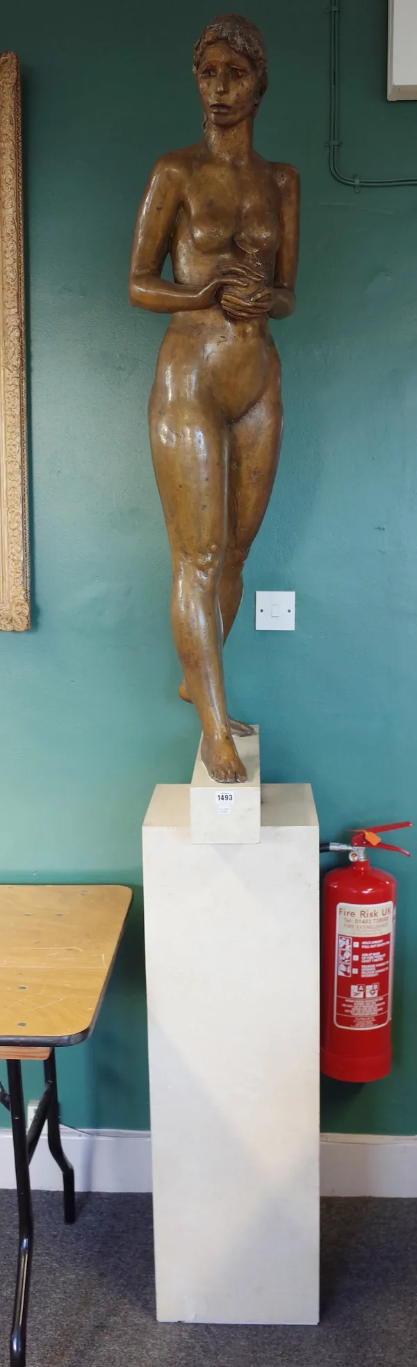 Female nude, late 20th century patinated bronze holding an apple, unsigned, on a marble pedestal, bronze 126cm high, 237cm high overall.