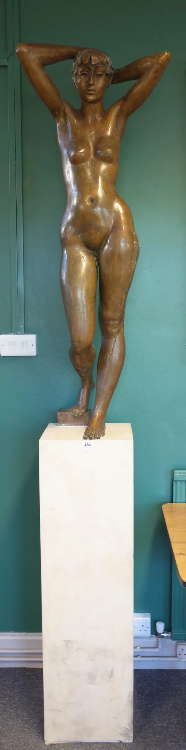 Female nude, late 20th century patinated bronze, arms raised behind head, unsigned, on a marble pedestal, bronze 130cm high, 241cm high overall.