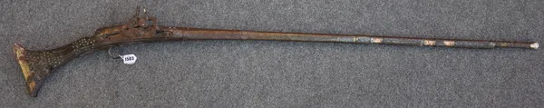 An early 19th century Jezail flintlock rifle, with metal overlay and horn butt to stock (a.f.) 149cm high.