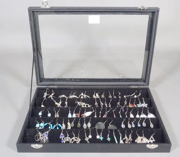 A large quantity of 20th century silver earrings within a display case, (qty).    CAB