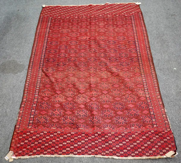 A Yomut embroidered flatweave carpet, the madder field with an all over hooked motif design, 310cm x 195cm.