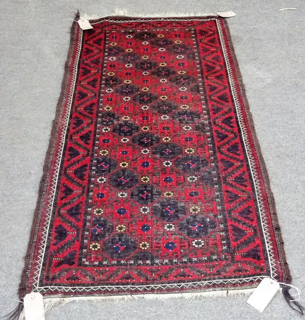 A Beluche rug, with a diagonal interlocking design of single hooked crosses, a tulip and serrated leaf border, 164cm x 80cm and an Afghan Kizil Ayak p