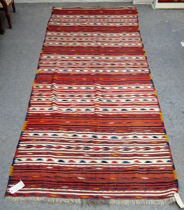 A Turkman gelim, with alternating banded design, 333cm x 138cm.