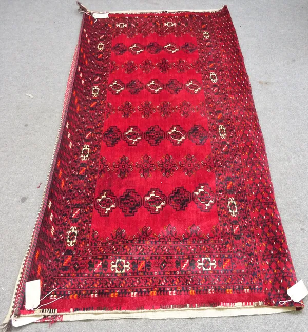 A pair of Afghan Esari chuvals, the madder field with four columns of five alternating guls, supporting 'bee' motifs, minor borders, plant skirt end,
