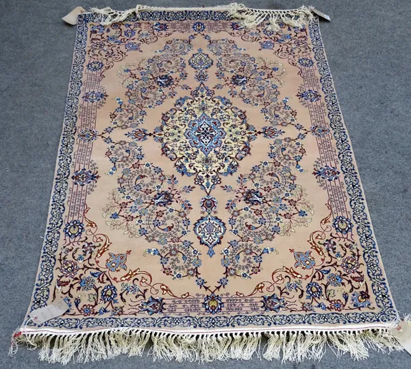 An Isfahan rug, Persian, the dull pink field with a cream pole medallion, trailing vine spandrels, delicate trailing floral sprays,a simple single bor
