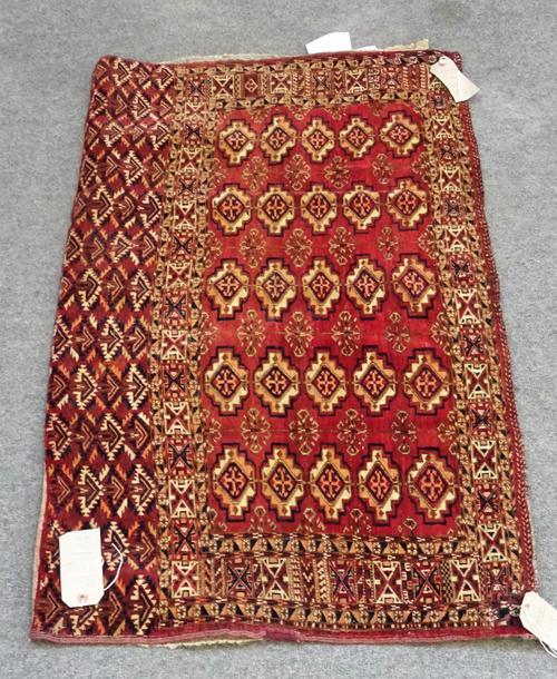 A Tekke Saryk chuval, the madder field with five columns of five guls, a box border, plant skirt end with backing, 71 x 118cm.