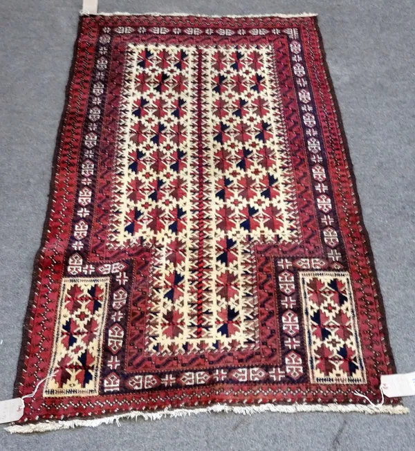 A Beluchistan prayer rug, the ivory mihrab filled with flowerheads, similar spandrels, three borders, 158 x 92cm.