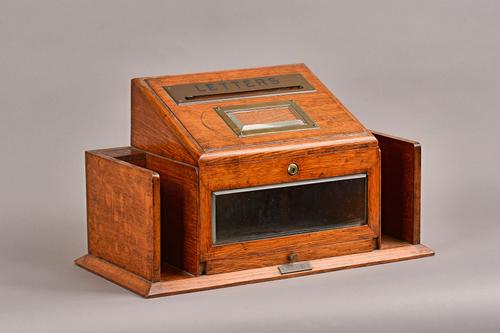 An Edwardian brass mounted oak internal hotel letter/telegram postal box, 47cm wide x 27cm high x 23cm deep. Illustrated.