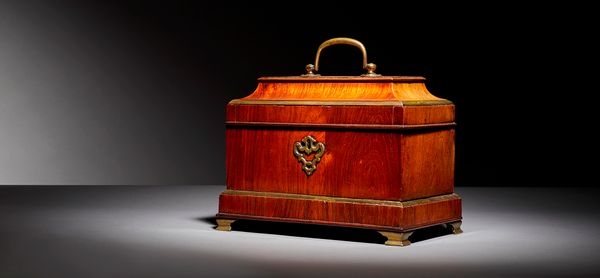Attributed to Abraham Roentgen; a mid 18th century German brass bound tulip wood sarcophagus tea caddy, with triple canister interior and side sprung