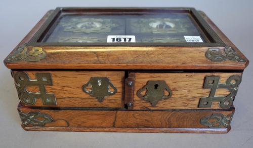 A 19th century gilt metal mounted rosewood card box, the glazed hinged lid enclosing four enamelled boxes above four divisions, 25cm wide.