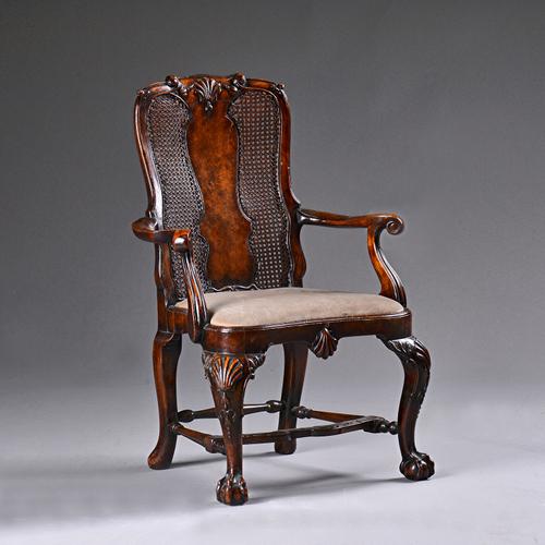 A diminutive walnut framed open armchair, of early 18th century design, on claw and ball feet, 42cm wide x 69cm high. Illustrated.