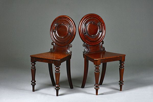 W. Priest, 1 & 2 Tudor St, Blackfriars, a pair of early Victorian mahogany hall chairs with carved rounded backs and solid seats on turned supports, 4