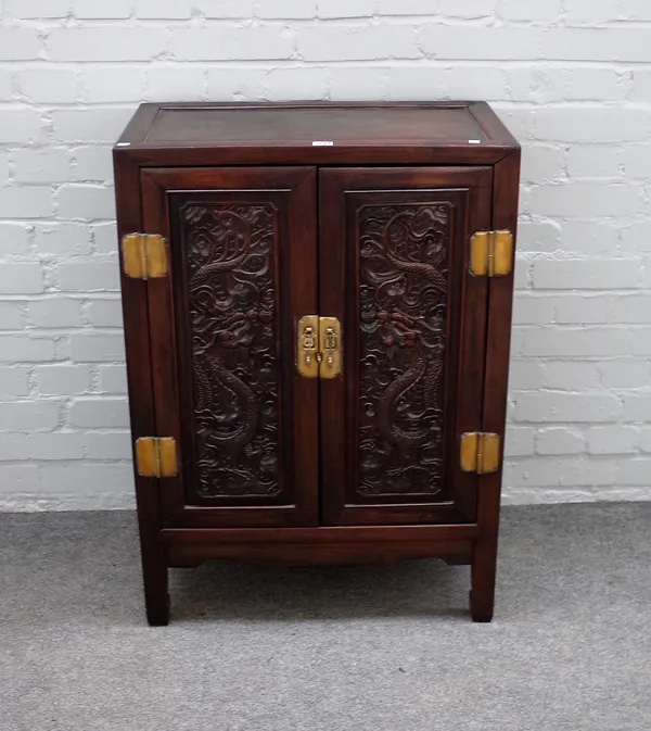 A 19th century Chinese hardwood side cabinet, with pair of dragon relief carved doors, on block feet, 66cm wide x 91cm high x 38cm deep.