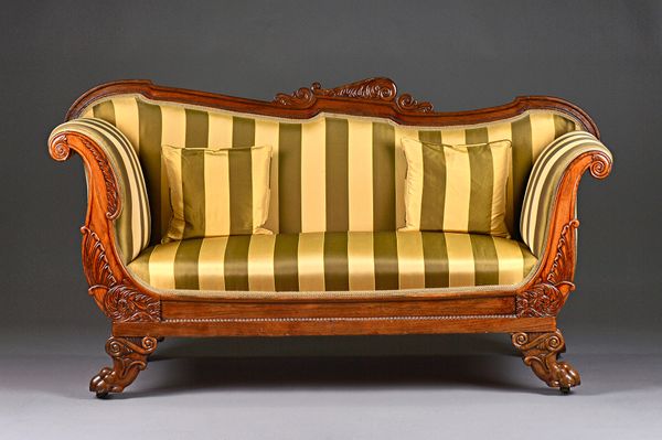A William IV rosewood sofa, with shaped crest rail and outswept arms on lion's paw capped scroll sabre supports, 173cm wide x 95cm high x 66cm deep. I