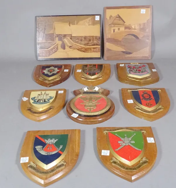 A group of eight 20th century oak shield back military emblems and two specimen wood panels, the larger 29cm wide x 20cm high, (10).   S2M