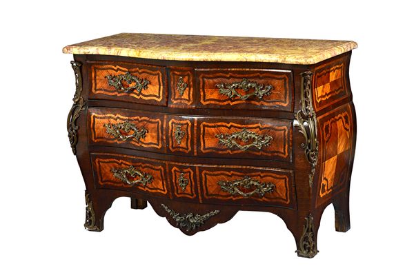 An 18th century Baltic commode, the serpentine marble top over a gilt metal mounted rosewood and kingwood bombé base with two short and two long drawe