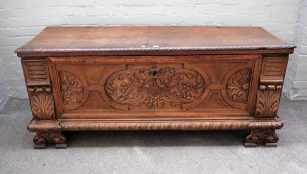An 18th century and later Italian walnut Cassone, the single plank top over carved panel front on shaped bracket feet, 167cm wide x 70cm high x 57cm d