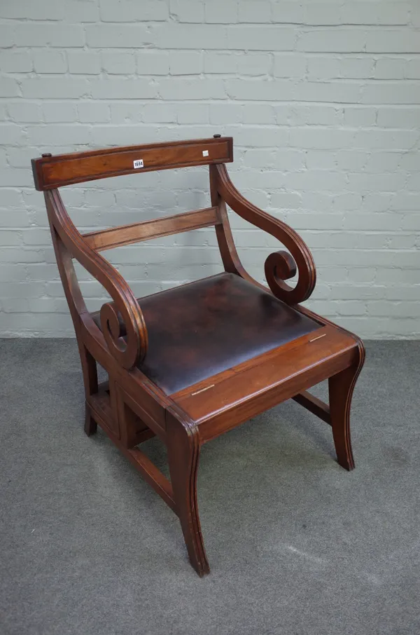 A Regency style large mahogany metamorphic library open armchair, with shepherd's crook arms and sabre supports, 60cm wide x 90cm high.