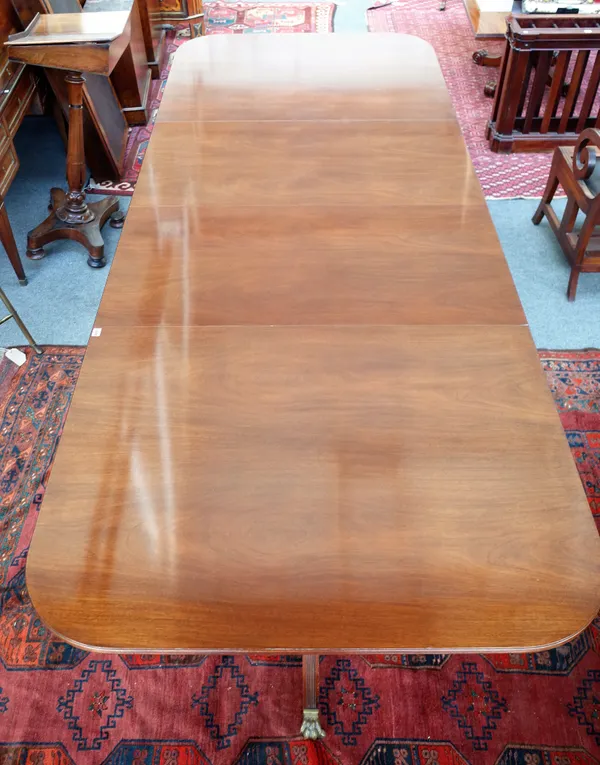 Probably Arthur Brett; a George III style mahogany twin pedestal extending dining table on six downswept supports, to include two extra leaves, 123cm