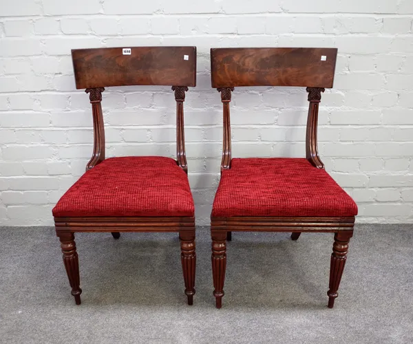 A set of eight William IV mahogany dining chairs with concave slab bar back on tapering reeded supports, 48cm wide x 88cm high.