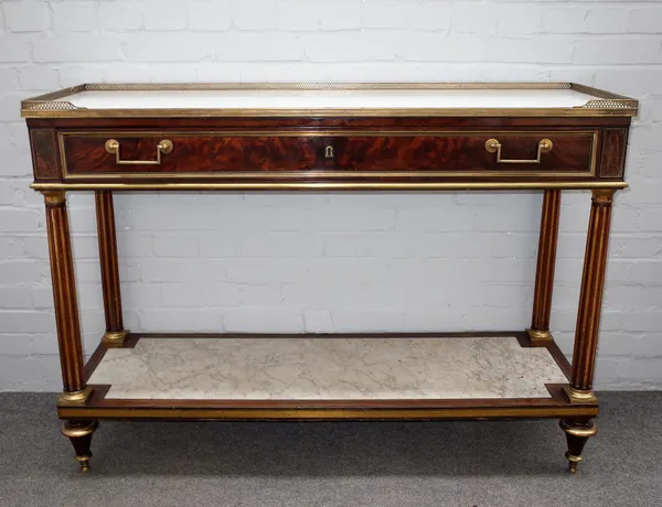 An early 19th century French brass mounted mahogany console, the galleried marble top over frieze drawer on fluted columns united by marble inset plat