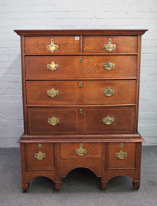 A mid-18th century provincial oak chest of two short over three long graduated drawers on a reduced three drawer stand, 102cm wide x 136cm high x 59cm