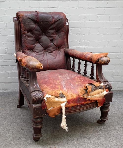 A Victorian mahogany framed rouge leather upholstered open armchair on turned supports, 70cm wide x 97cm high.