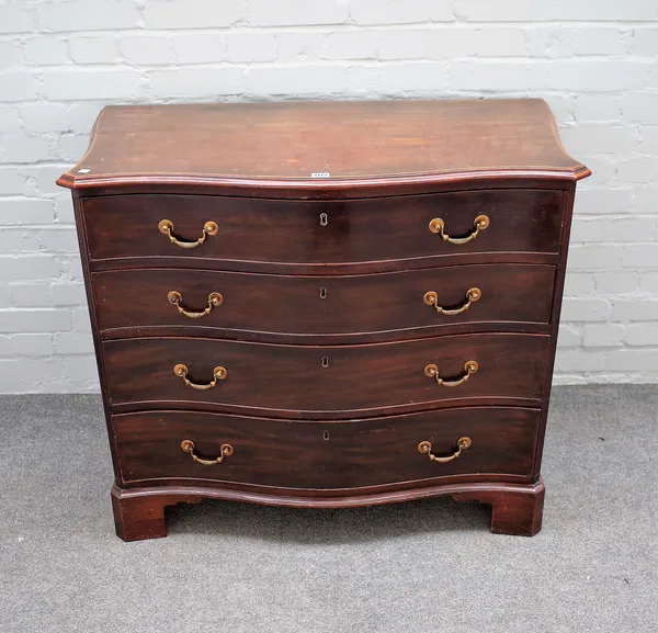 A George III mahogany serpentine dressing chest of four long graduated drawers, on bracket feet, the top drawer revealing a fitted interior, 97cm wide
