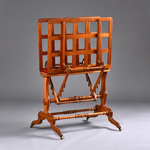 After Holland & Son, a Victorian double action folio stand on silhouette trestle supports and four downswept feet, 71cm wide x 113cm high. Illustrated