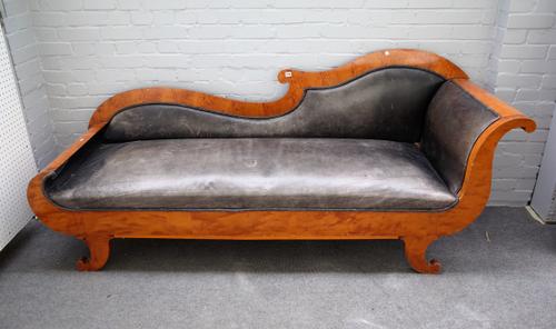 A mid 19th century North European Biedermeier birch sofa with rollover ends on squat splayed sabre supports, 220cm wide x 93cm high.